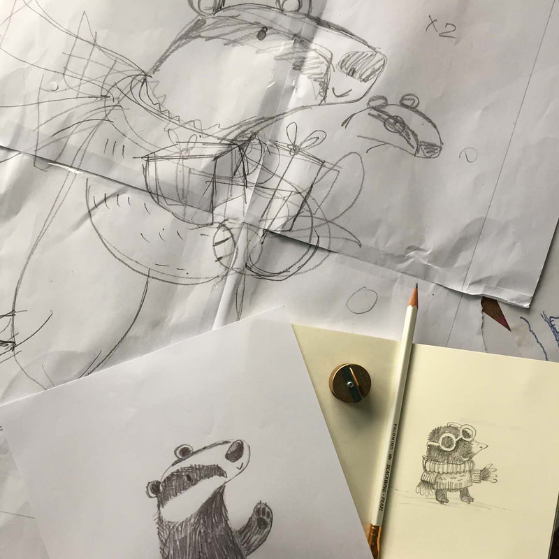 sketches of a badger and a mole on paper with a pencil and pencil sharpener