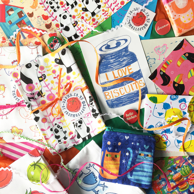 overhead view of printed cards and tea towels with bright illustrations by Jo Brown